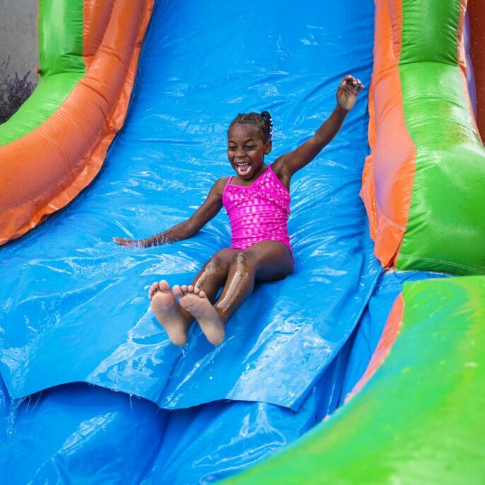 Full Girl on Inflatable Water Slide - 254 Party Rentals - China Springs Texas